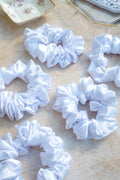 White scrunchies on a textured surface