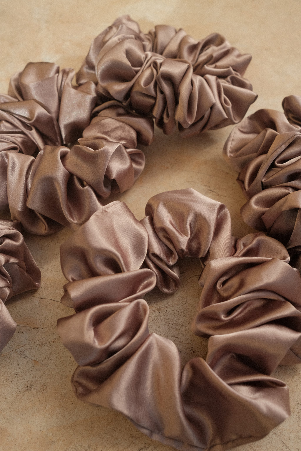 Brown scrunchies on a beige background