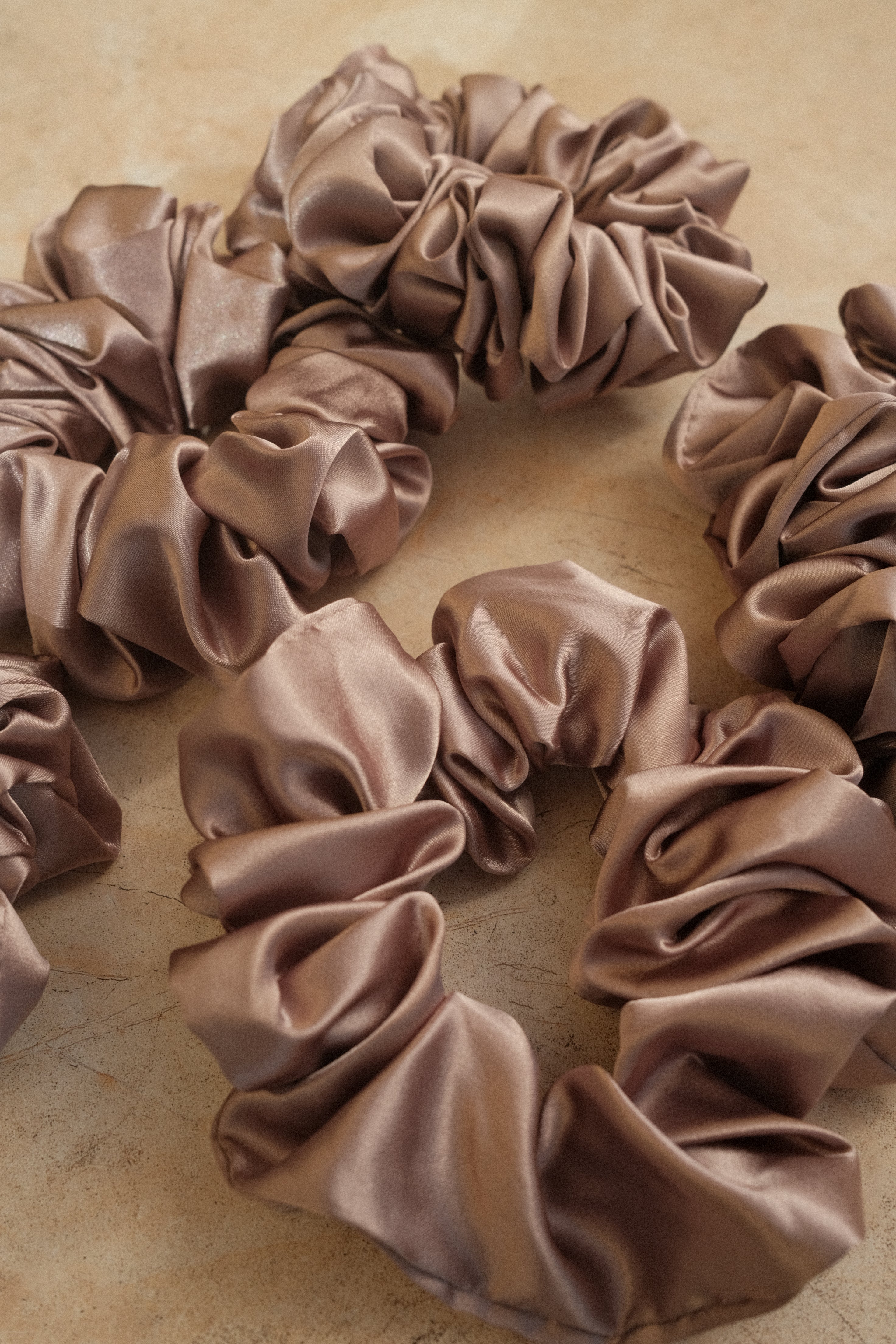Brown scrunchies on a beige background