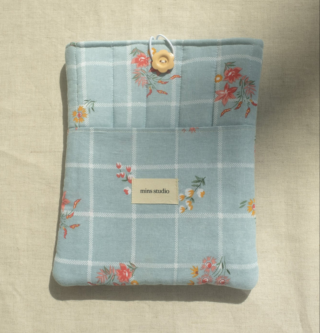 Folded fabric with floral pattern on a beige surface