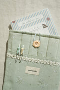 Sage booksleeve with diary inside and two pens in the front pocket