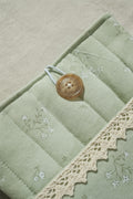 Sage booksleeve close up on button and lace detail