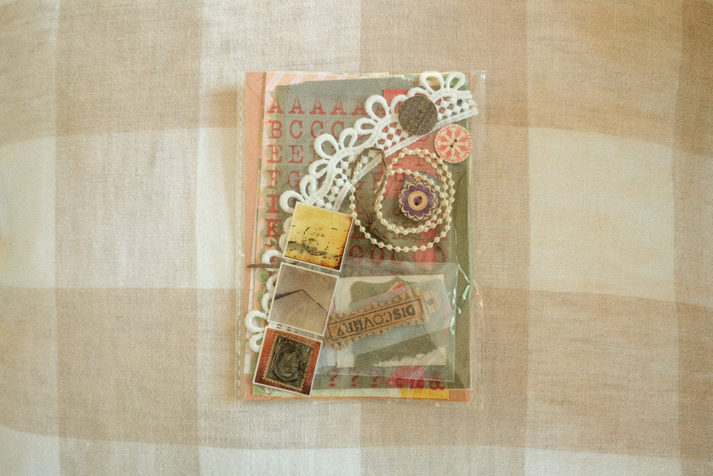 Packaged decorative items with lace and vintage-style packaging on a checkered fabric background