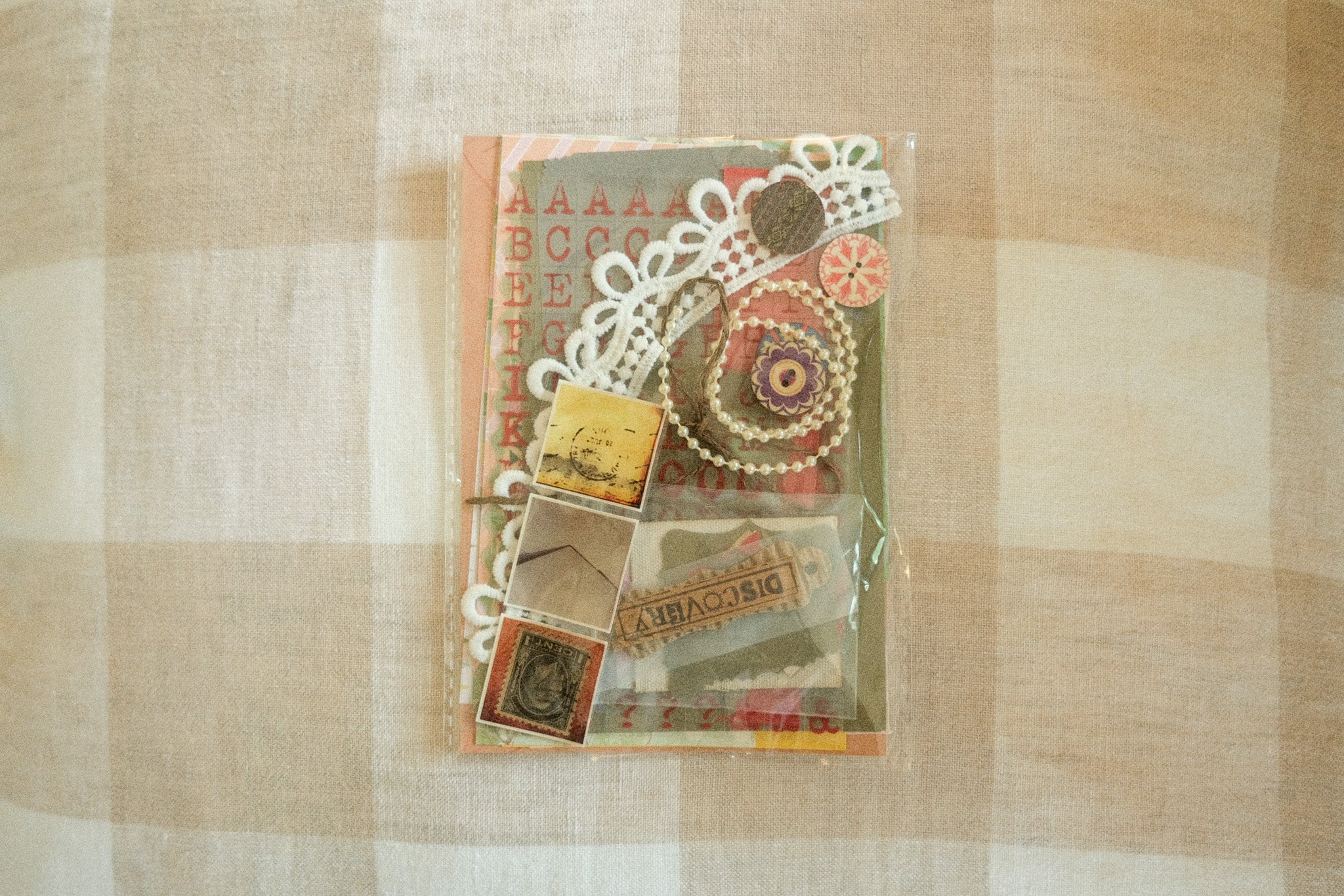 Packaged decorative items with lace and vintage-style packaging on a checkered fabric background