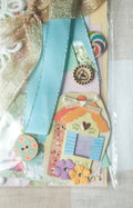 Colorful paper embellishments on a textured surface