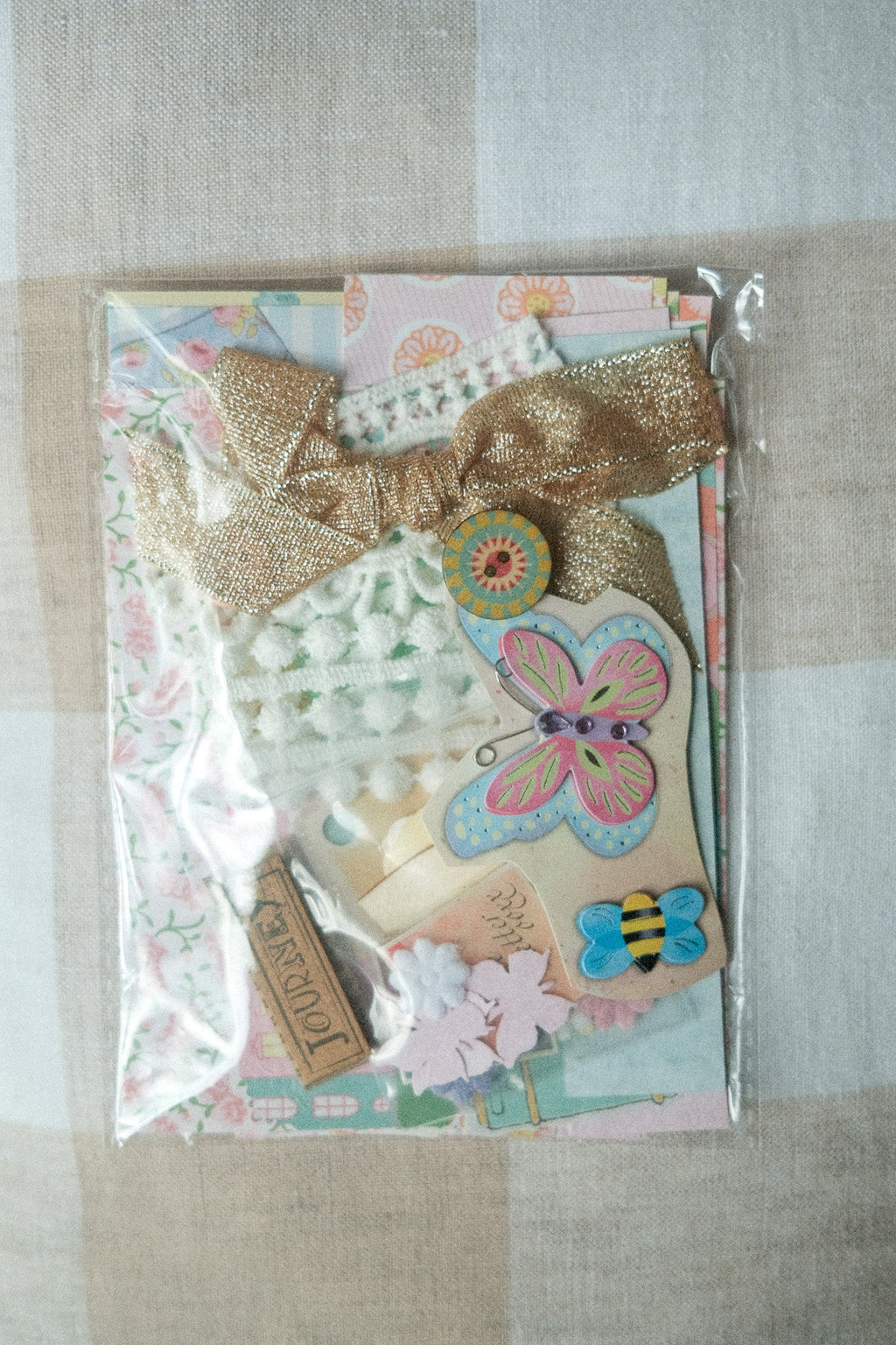 Decorative package with butterfly design and decorative elements on a textured surface
