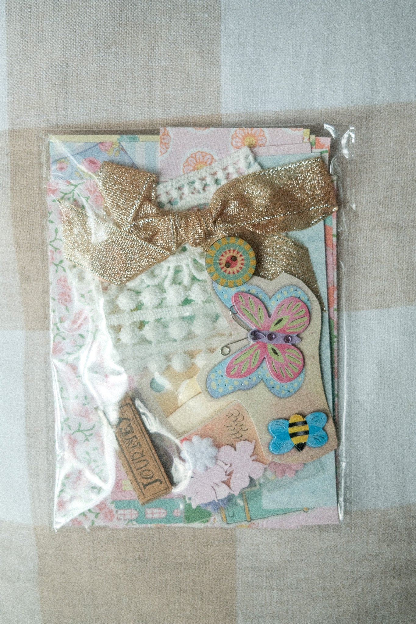 Decorative package with butterfly design and decorative elements on a textured surface