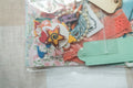 Decorative items including a star-shaped object, ribbons, and a card on a light surface.