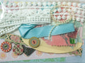 Decorative paper with ribbons and embellishments on a checkered fabric background