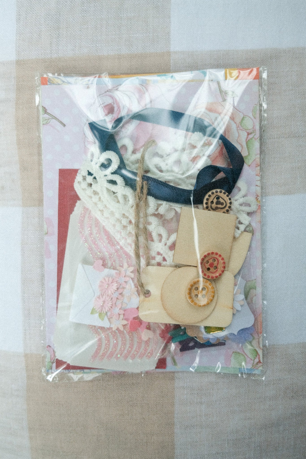 Packaged craft item with decorative elements on a patterned background