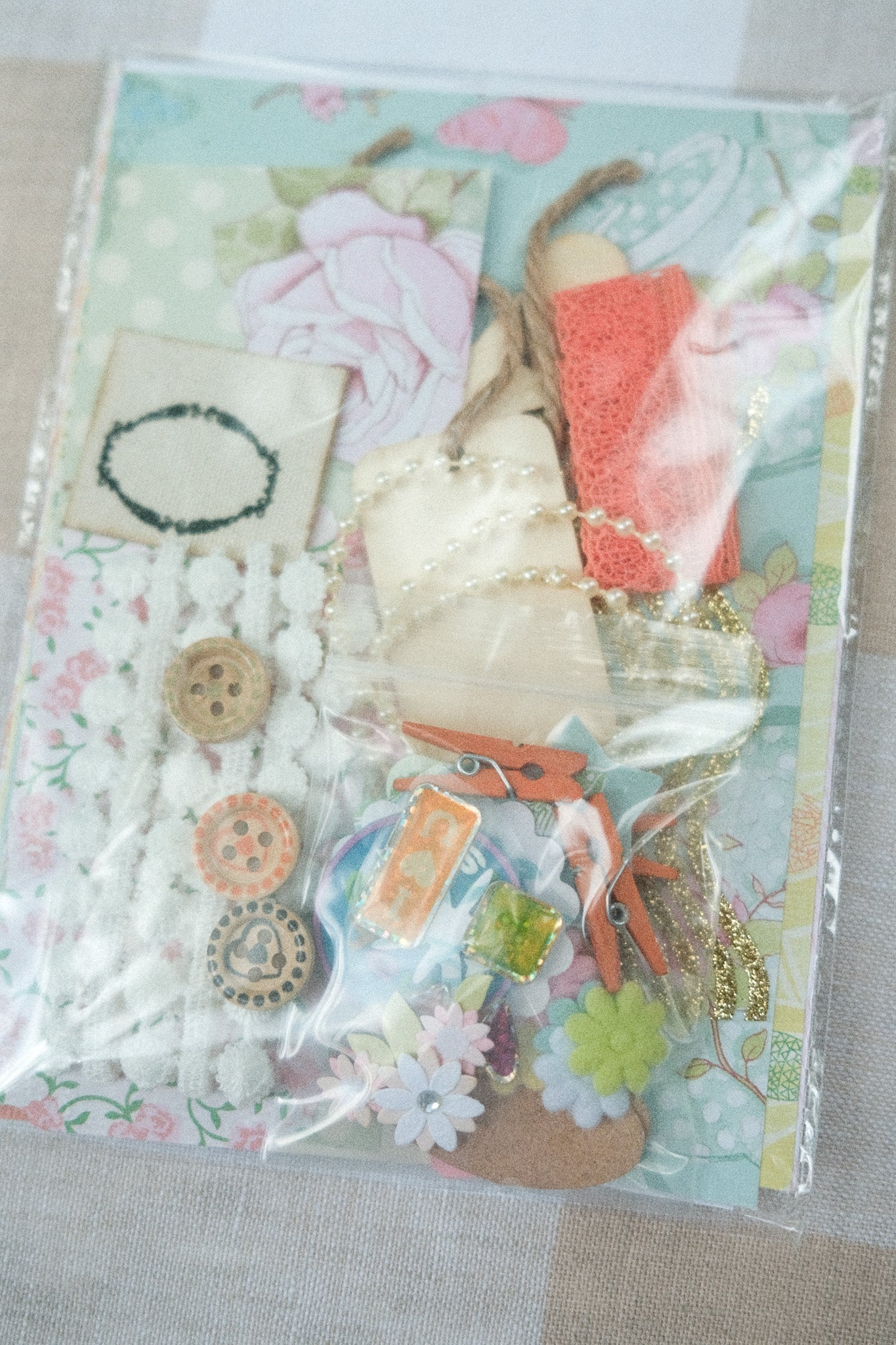 Packaged craft supplies with decorative elements on a light background