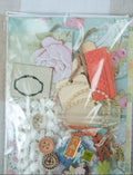 Collection of decorative items including buttons, ribbons, and a card with flowers on a floral-patterned background.