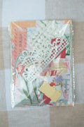 Decorative paper bags with floral designs on a checkered fabric background