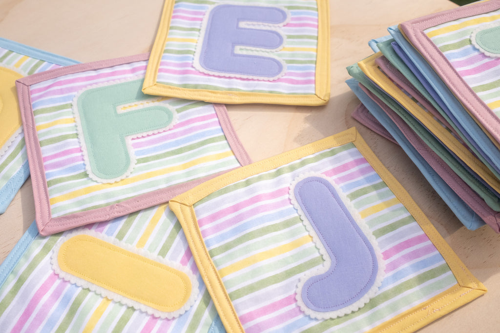 Colorful children's educational letters on a wooden surface
