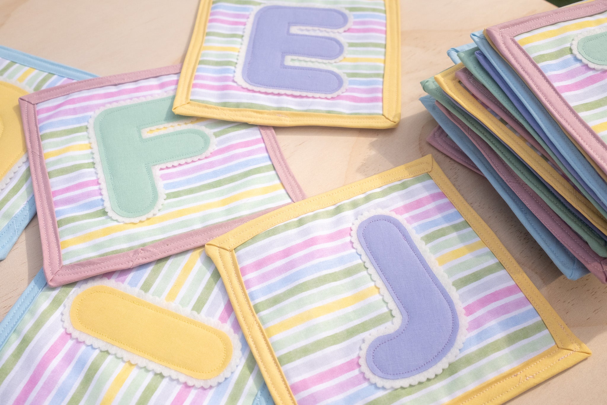 Colorful children's educational letters on a wooden surface