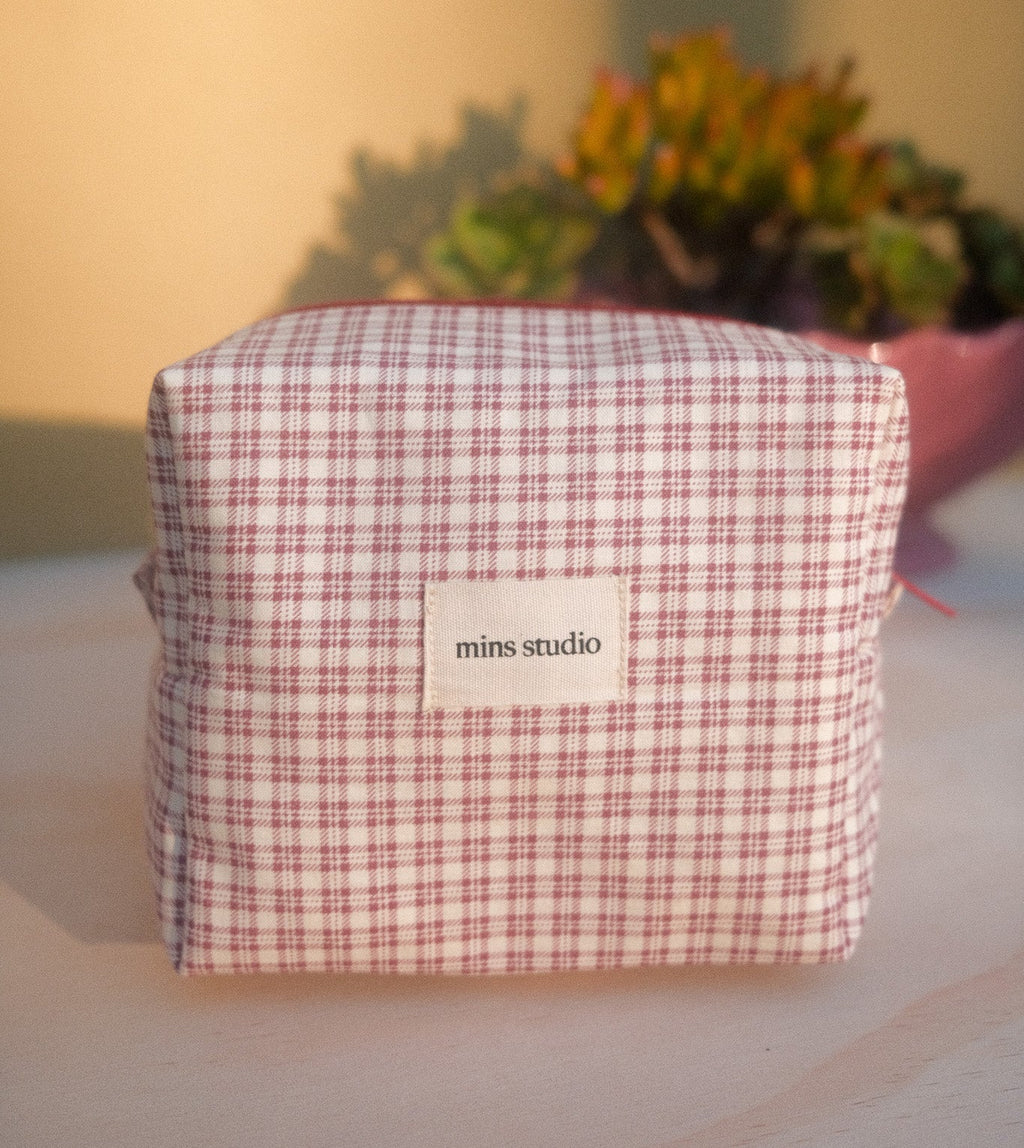 Checkered pouch with 'mins studio' label 