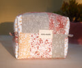 Patchwork pouch with floral patterns on a wooden surface